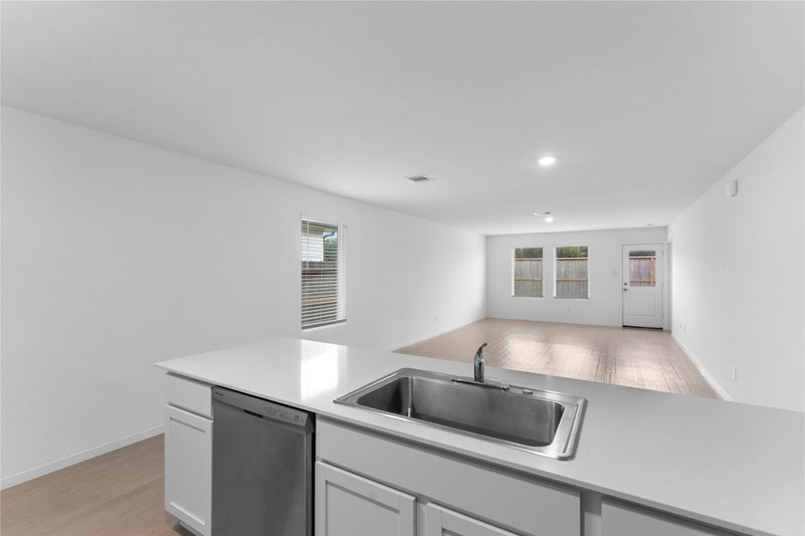 Three windows bring plenty of natural light into the spacious living room.