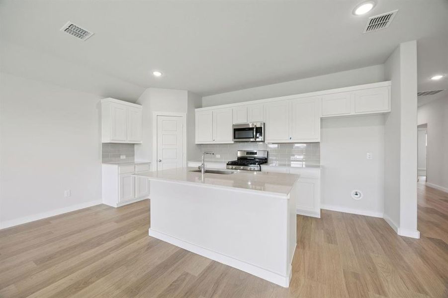 Kitchen in the Hadley home plan by Trophy Signature Homes – REPRESENTATIVE PHOTO