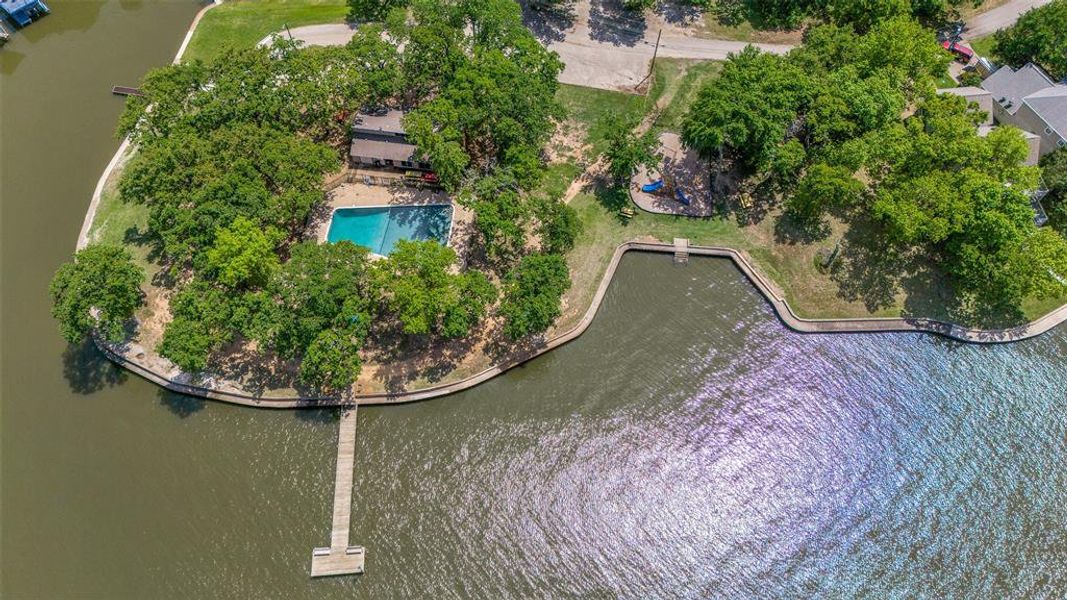 Aerial view of the gated community pool and dock. Aerial view of the gated community pool and dock.