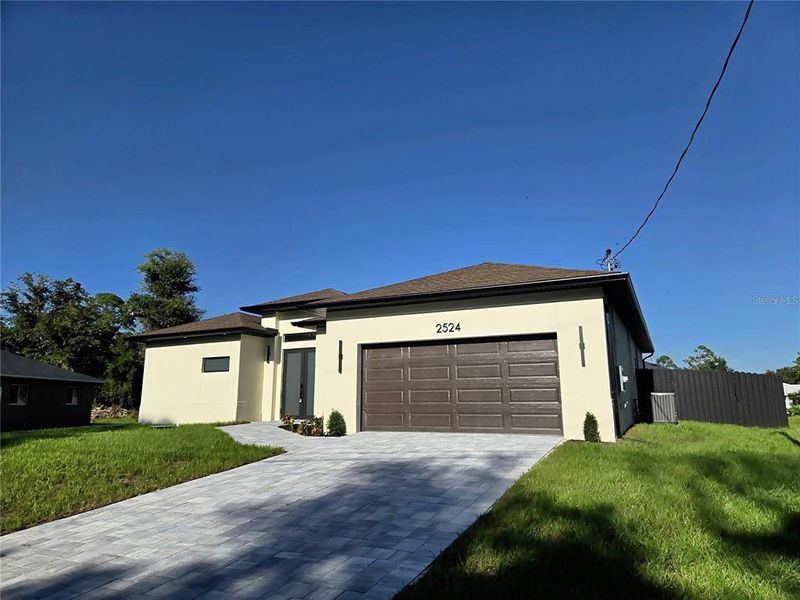 Front exterior of a new home in , North Port, FL, highlighting curb appeal (Image 2). Front exterior of a new home in , North Port, FL, highlighting curb appeal (Image 2).