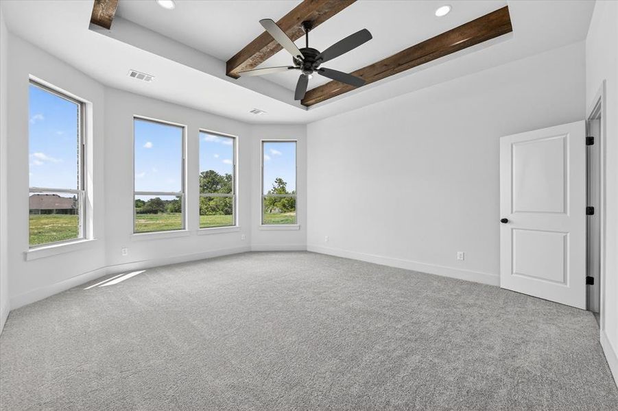 Unfurnished room featuring carpet flooring, ceiling fan, a raised ceiling, beam ceiling, and recessed lighting