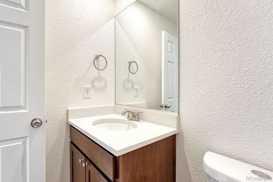 Half bath with your choice of cabinetry and countertop is on the main level. Undermount sink is standard.
