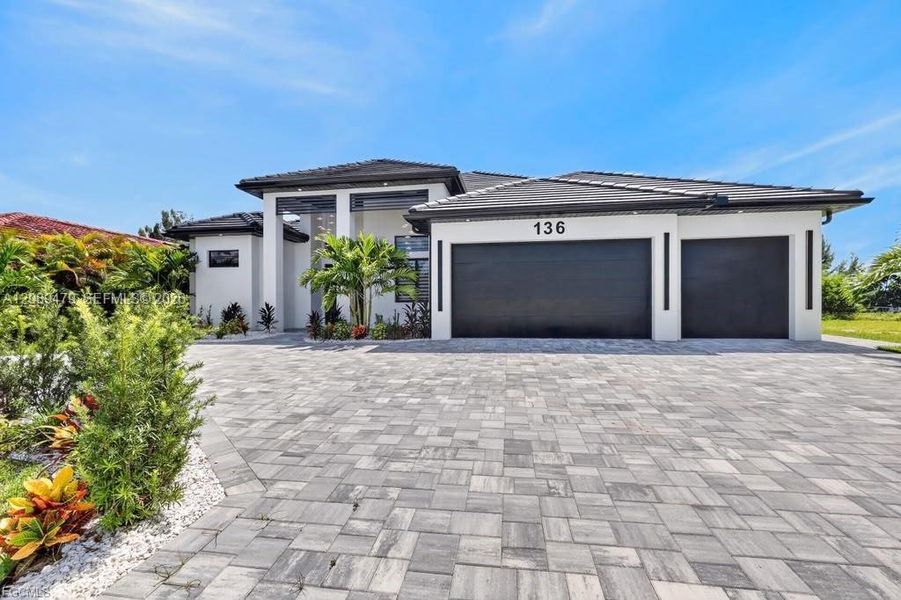 Front exterior of a new home in , Cape Coral, FL, highlighting curb appeal (Image 2). Front exterior of a new home in , Cape Coral, FL, highlighting curb appeal (Image 2).