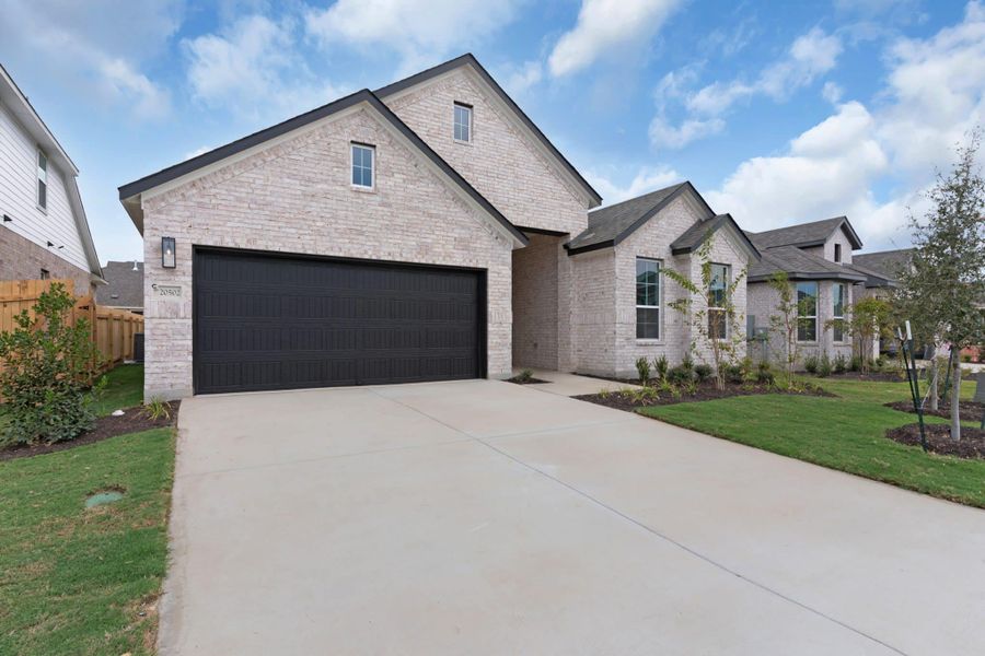 Front exterior of a new home in Parkside on the River, Georgetown, TX, highlighting curb appeal (Image 27).