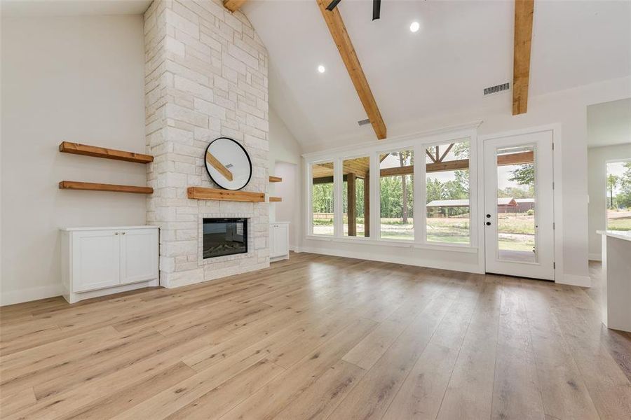 Vaulted ceiling featuring exposed wood beams and recessed lighting