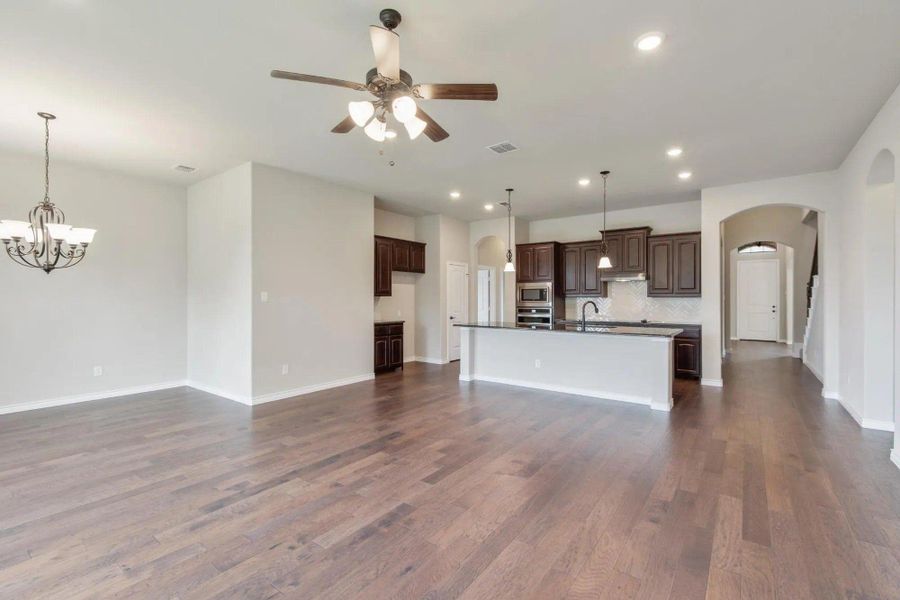 Family Room & Kitchen | Concept 2671 at Mockingbird Hills in Joshua, TX by Landsea Homes