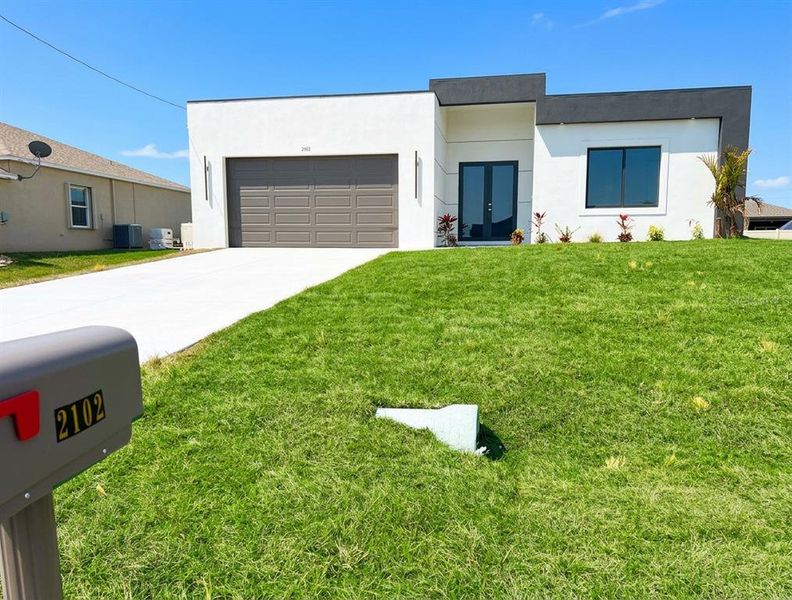 Front exterior of a new home in , Cape Coral, FL, highlighting curb appeal (Image 16).