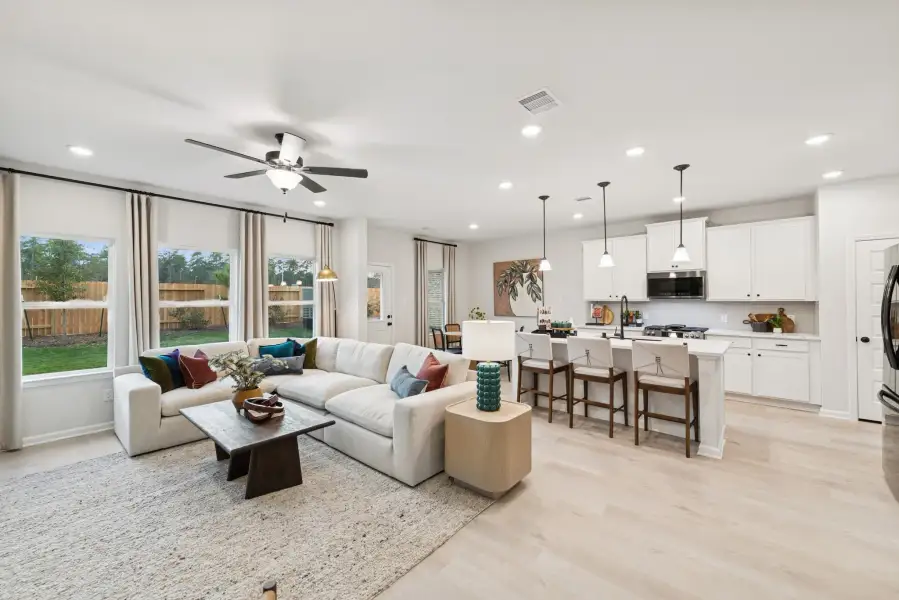 The Princeton II- Family Room and Kitchen. Staged model home shown for illustration only; actual features, colors, and upgrades may vary.