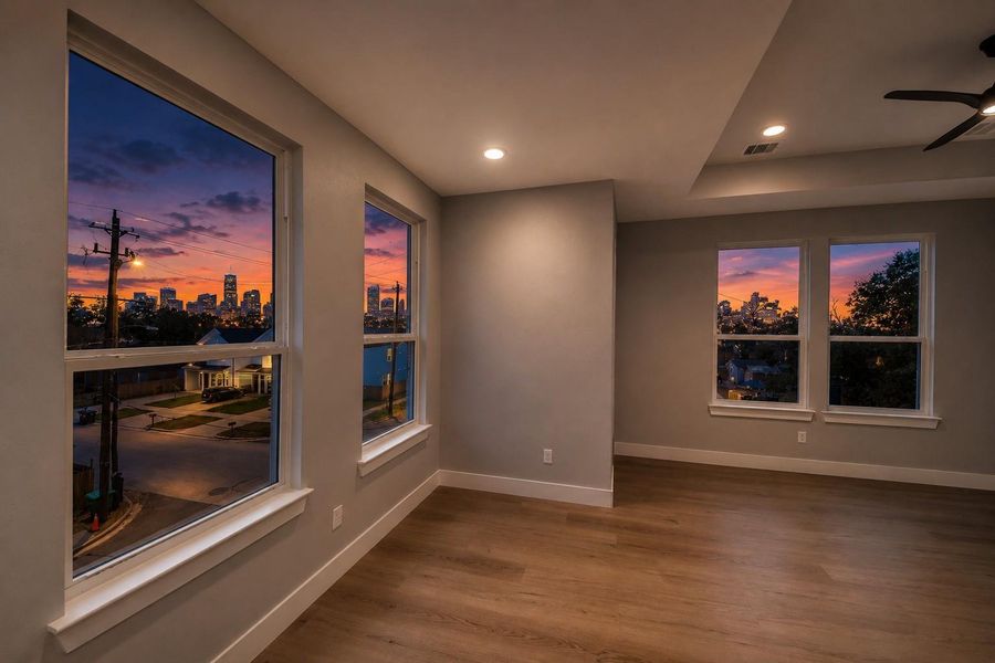 Expansive living room windows showcase breathtaking Downtown Houston skyline views, creating the perfect urban backdrop day & night.