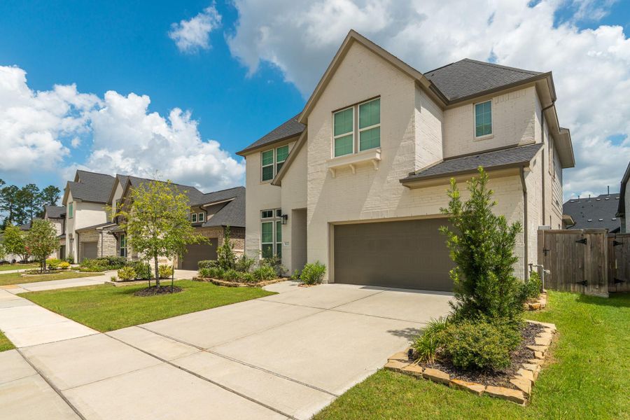 Front exterior of a new home in Lakes at Creekside 50′, Tomball, TX, highlighting curb appeal (Image 2). Front exterior of a new home in Lakes at Creekside 50′, Tomball, TX, highlighting curb appeal (Image 2).