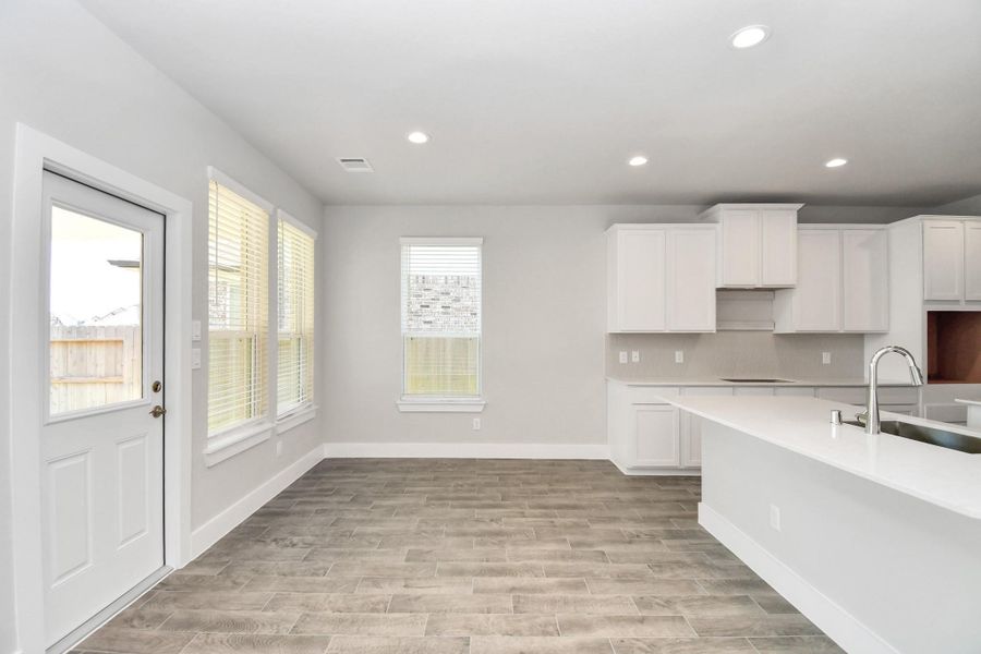 Enjoy breakfast with ease in the connected and cozy breakfast area, seamlessly integrated with the kitchen for utmost convenience. Step through the back door for a breath of fresh air onto the covered patio, extending your living space to the outdoors Enjoy breakfast with ease in the connected and cozy breakfast area, seamlessly integrated with the kitchen for utmost convenience. Step through the back door for a breath of fresh air onto the covered patio, extending your living space to the outdoors