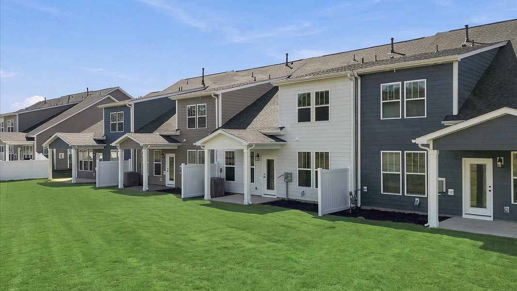 Vibrant rear outdoor space featuring a covered porch and exceptional craftsmanship at Barton Hollow