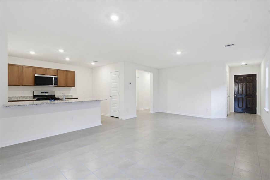 Bring family and friends together in this beautiful space! It features high ceilings, recessed lighting, custom paint, stunning and durable tile flooring, and large windows - which will fill the space with natural light all day long.