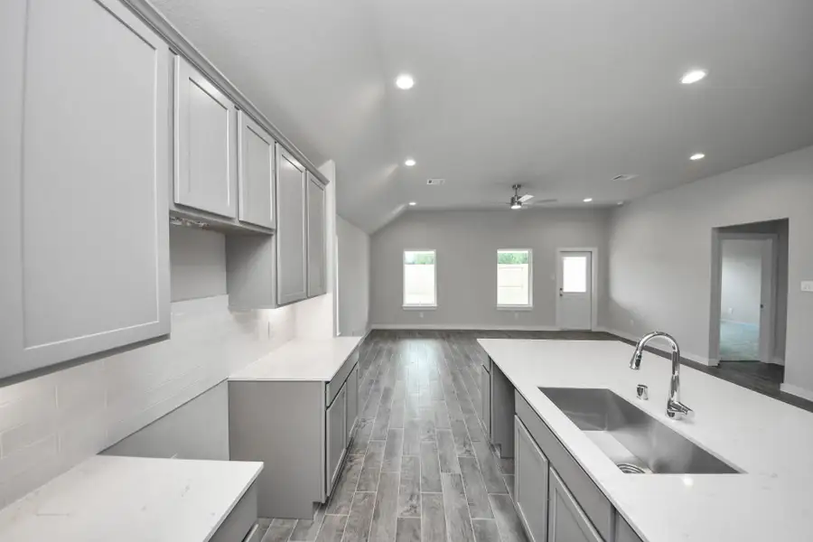 All of this overlooks your expansive family room, creating a perfect space for culinary delights and family gatherings. Sample photo of completed home with similar floor plan. Actual colors and selections may vary. All of this overlooks your expansive family room, creating a perfect space for culinary delights and family gatherings. Sample photo of completed home with similar floor plan. Actual colors and selections may vary.