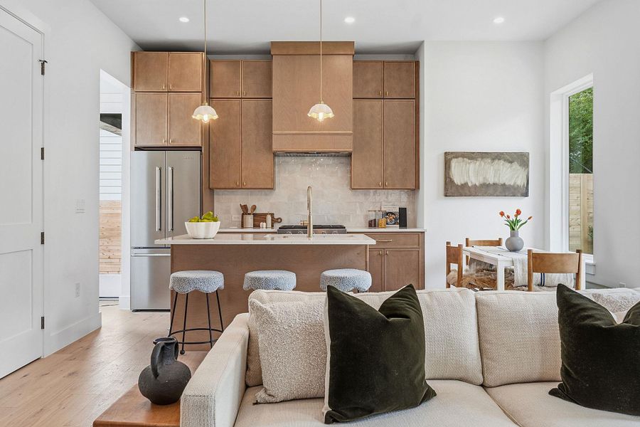 Open-concept living space with light wood-finish flooring