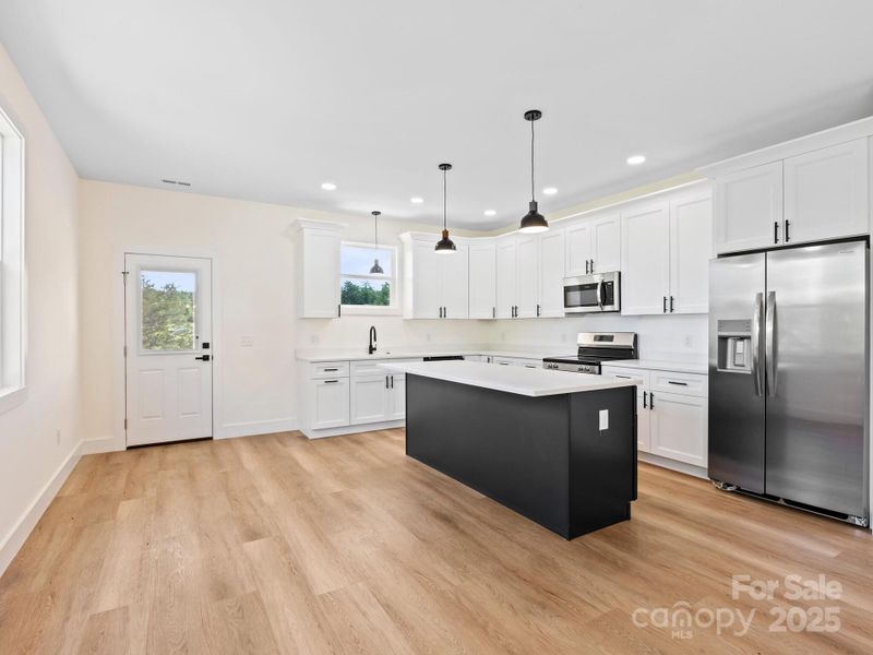 The bright kitchen sits at the back of the home with a door opening onto the large deck.  Convenient for grilling or dinning al fresco as you look out at the view.
