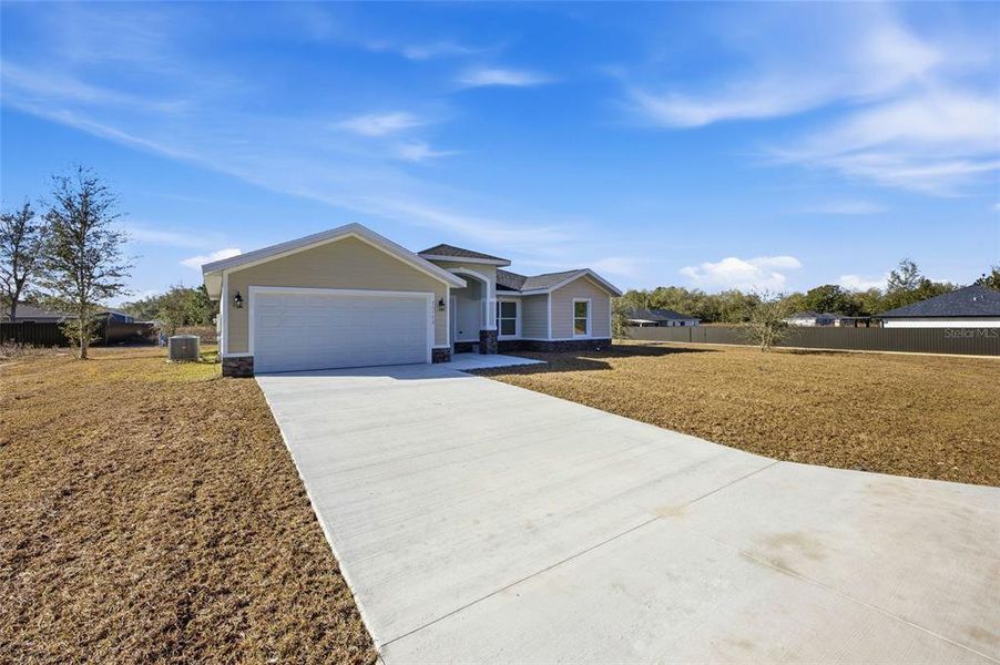 Front exterior of a new home in , Dunnellon, FL, highlighting curb appeal (Image 19).