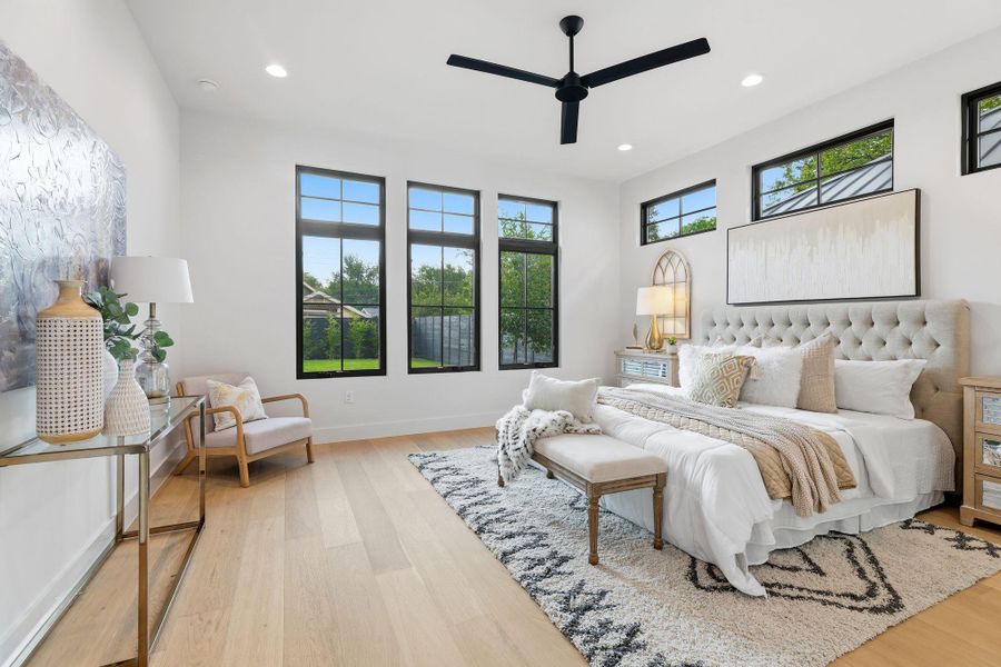 Bedroom with light wood-style floors, recessed lighting, and a ceiling fan