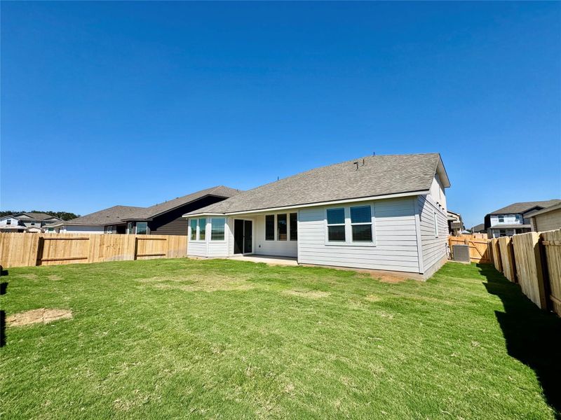 Back of house featuring a patio, a fenced backyard, and a shingled roof Back of house featuring a patio, a fenced backyard, and a shingled roof