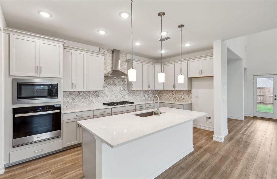 Bright kitchen with oversized island *real home pictured