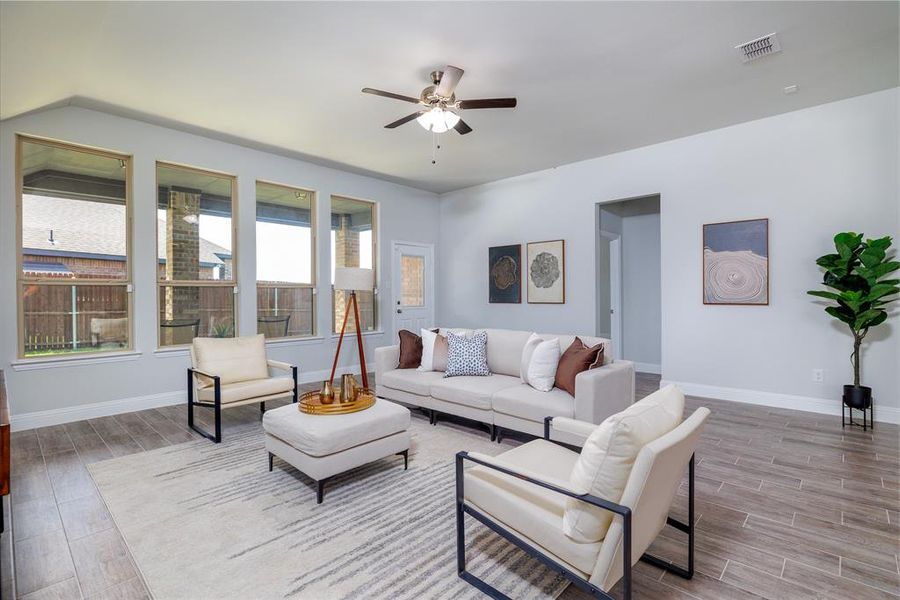 Living area with ceiling fan and wood tiled floors