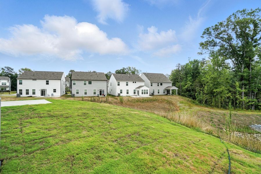 Front exterior of a new home in Hampton Woods, Charlotte, NC, highlighting curb appeal (Image 26). Front exterior of a new home in Hampton Woods, Charlotte, NC, highlighting curb appeal (Image 26).