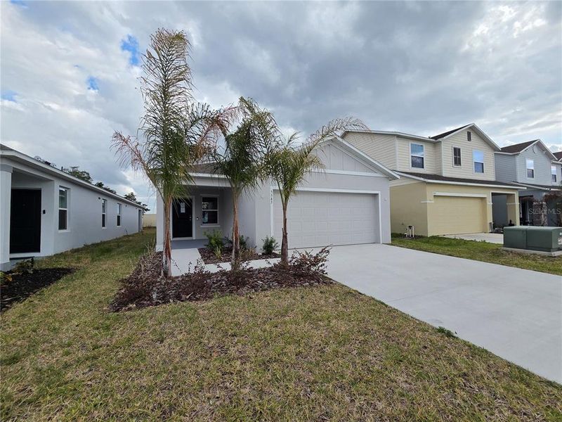 Front exterior of a new home in Hammock Reserve, Haines City, FL, highlighting curb appeal (Image 2). Front exterior of a new home in Hammock Reserve, Haines City, FL, highlighting curb appeal (Image 2).