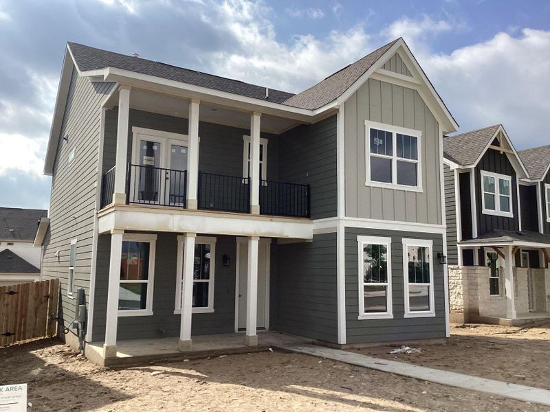 Exterior details and patio area of a home in The Cottages at Lariat, Liberty Hill (Image 7).