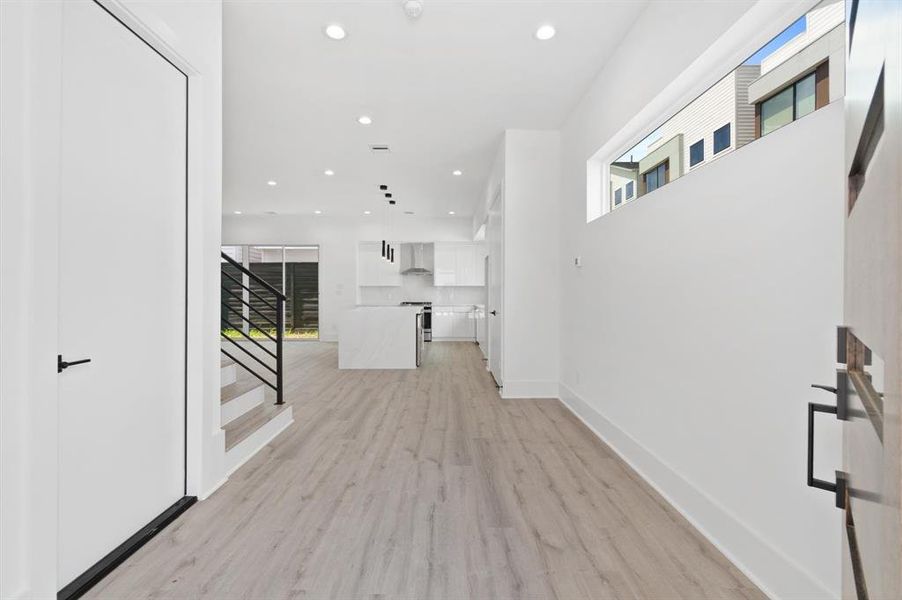 Entry hallway leading to an open flow kitchen.