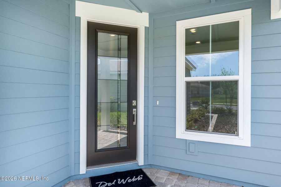 Exterior details and patio area of a home in Del Webb Wildlight, Wildlight (Image 23).