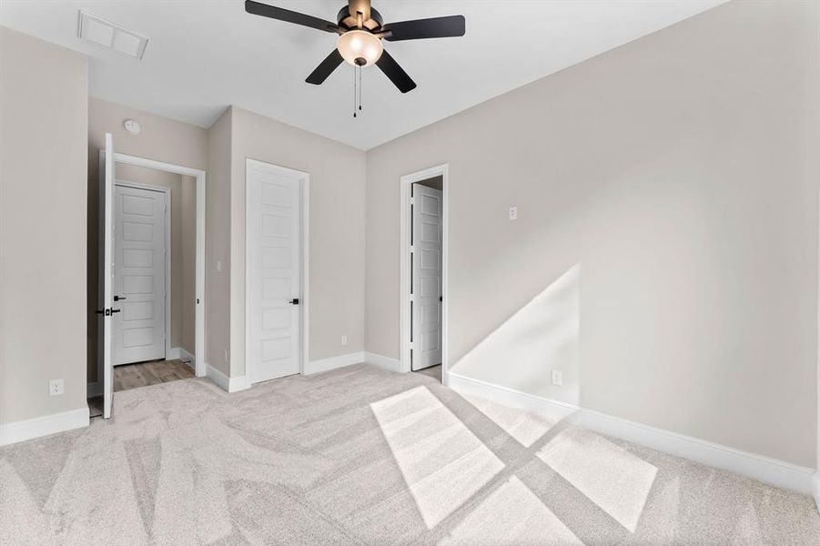 Secondary bedroom with walk-in closet and private bath