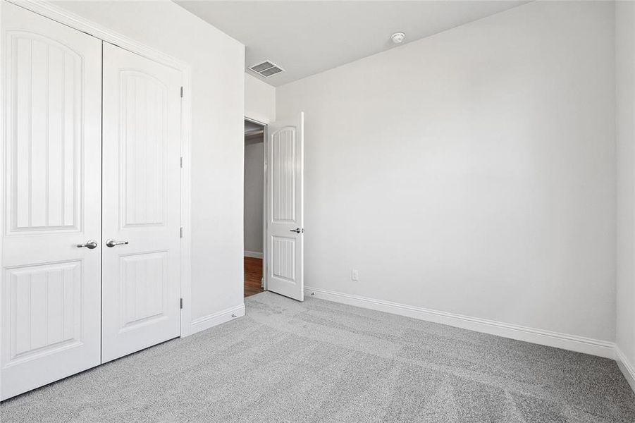 Unfurnished bedroom featuring carpet floors and a closet