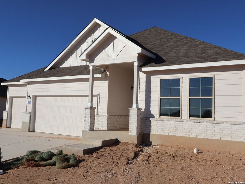 Front exterior of a new home in Hickory Ridge, Elmendorf, TX, highlighting curb appeal (Image 26).