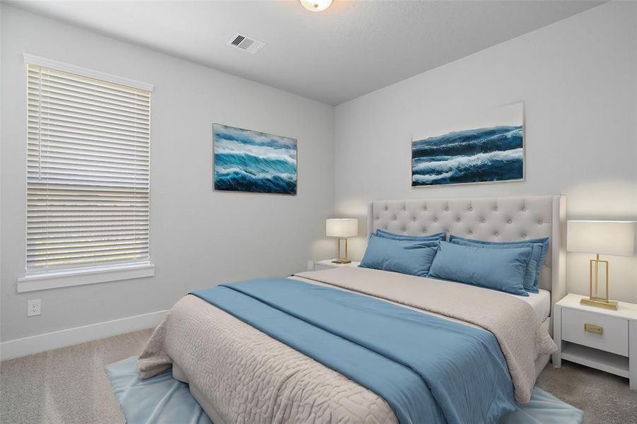 Secondary bedroom features plush carpet, custom paint and a large window with privacy blinds.