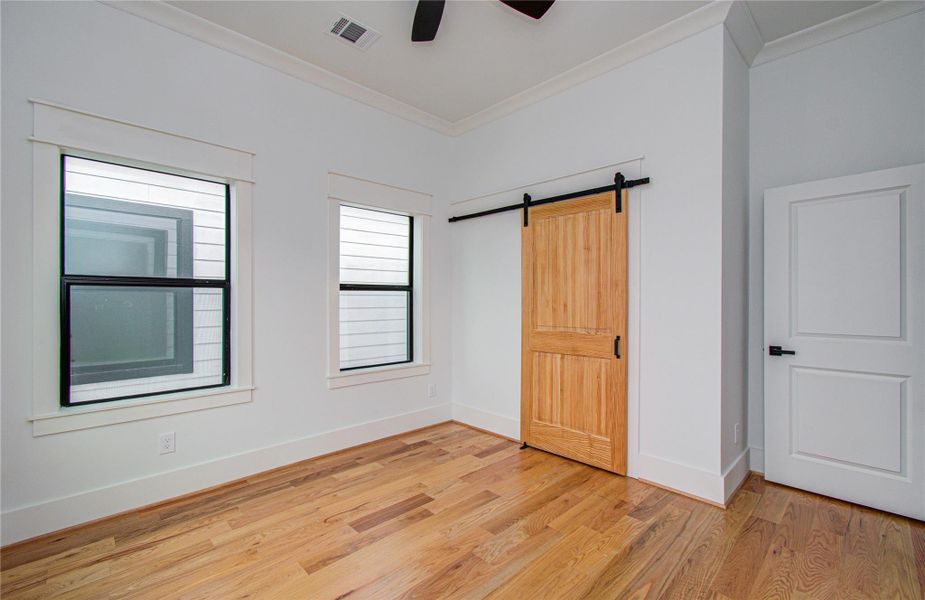 Bright third bedroom features hardwood floors, large windows for natural light.