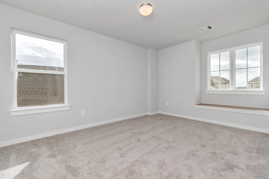 Step into this inviting bedroom retreat, boasting generously sized secondary bedrooms, plush carpeting underfoot, and ample natural light flooding through the large windows. With spacious closets to accommodate all your storage needs, this bedroom offers comfort and functionality in equal measure. Sample photo of completed home with similar floor plan. As-built interior colors and selections may vary.