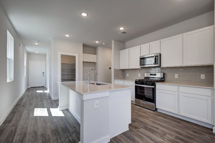 A kitchen with white cabinets. A kitchen with white cabinets.