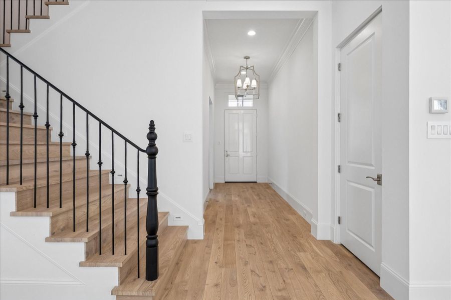 Step into this bright and welcoming formal entry. The first floor living space features 11-foot ceilings, Legno Bastone engineered White Oak wood floors, and designer light fixtures. All homes come with a pre-equipped elevator shaft for optional elevator upgrade.
