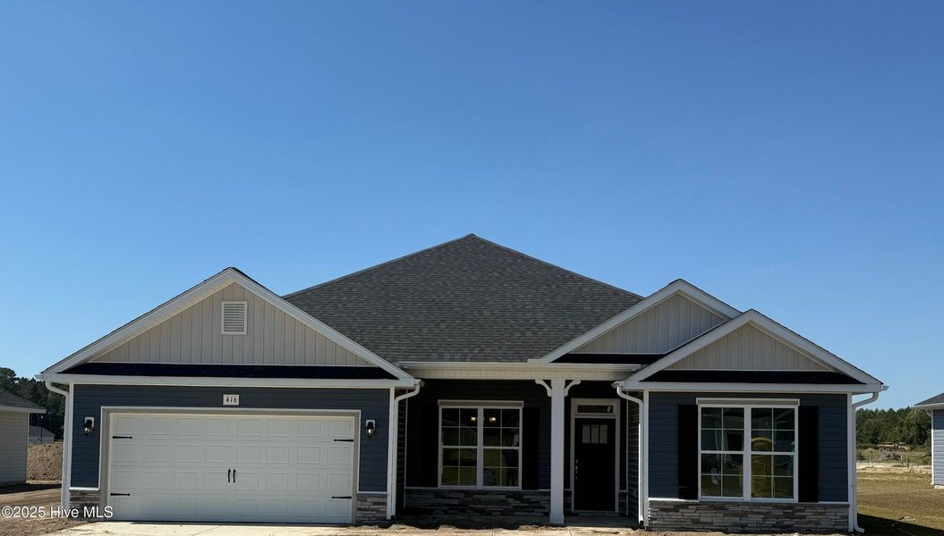 Front exterior of a new home in Summer Place, Grimesland, NC, highlighting curb appeal (Image 1).