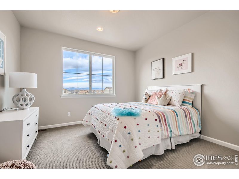 Second bedroom *Photo not of actual home, but same floorplan and style/colors*