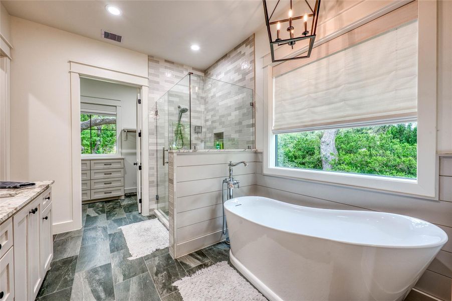 Freestanding soaking tub with floor-mounted faucet