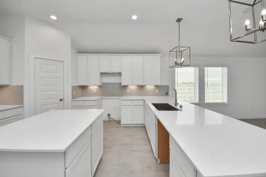 The open concept effortlessly connects the kitchen to the expansive family room, forming a perfect hub for gatherings. This seamless flow creates an inviting space where cooking and socializing come together harmoniously. Sample photo of completed home with similar floor plan. Actual colors and selections may vary.