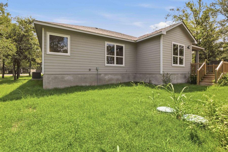 A newly constructed residence features modern siding and an inviting deck leading to the entrance. A newly constructed residence features modern siding and an inviting deck leading to the entrance.
