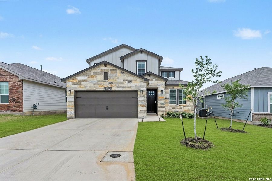 Front exterior of a new home in Hickory Ridge, Elmendorf, TX, highlighting curb appeal (Image 2). Front exterior of a new home in Hickory Ridge, Elmendorf, TX, highlighting curb appeal (Image 2).