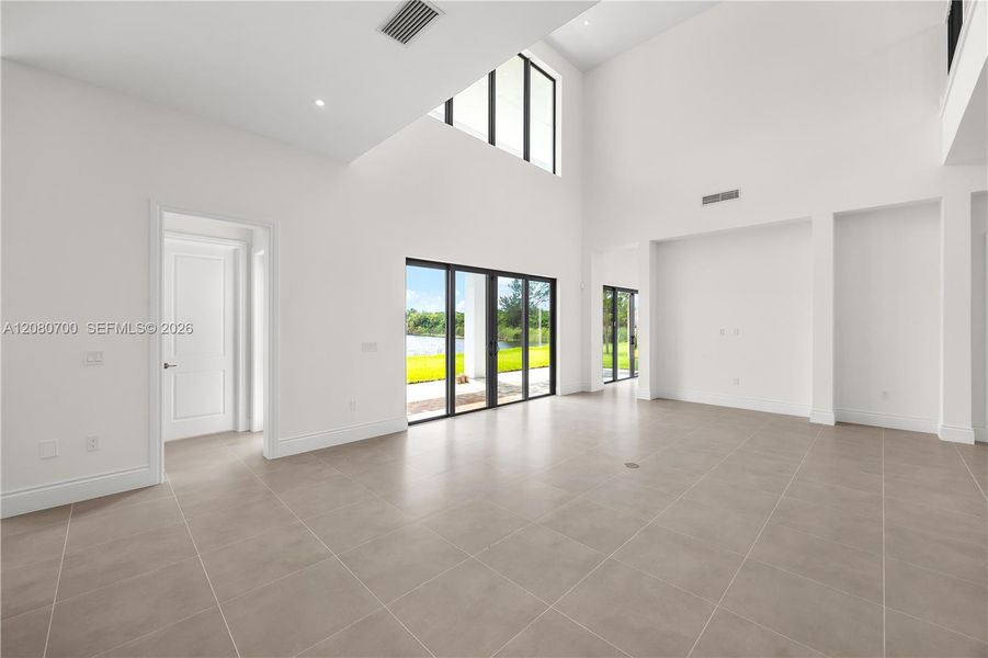 Vaulted ceilings, recessed lighting, and large format tile flooring
