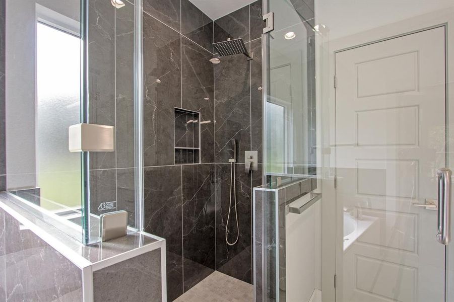 The frameless shower exudes a sleek, modern look.