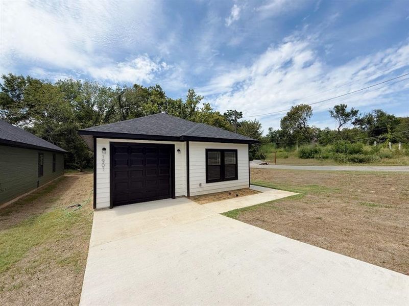Garage featuring driveway Garage featuring driveway