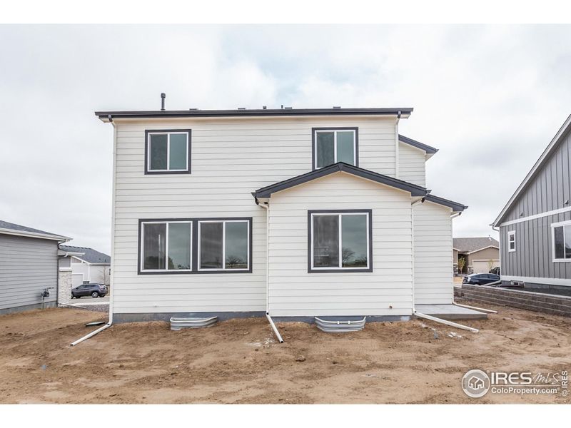 Front exterior of a new home in Promontory Point, Greeley, CO, highlighting curb appeal (Image 21). Front exterior of a new home in Promontory Point, Greeley, CO, highlighting curb appeal (Image 21).