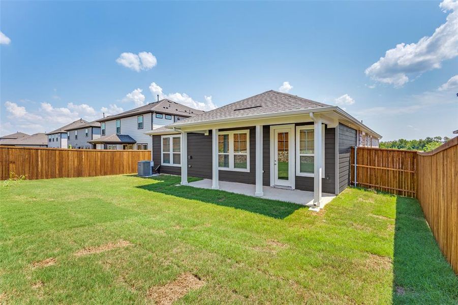 Rear view of property featuring a fenced backyard, a patio, and a shingled roof Rear view of property featuring a fenced backyard, a patio, and a shingled roof
