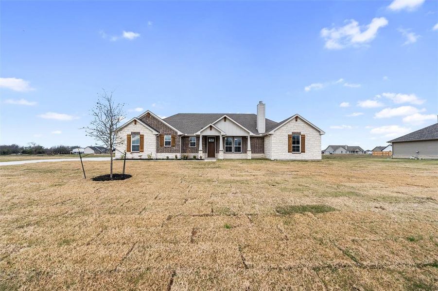 View of front of house featuring a chimney, a front lawn, and a porch View of front of house featuring a chimney, a front lawn, and a porch